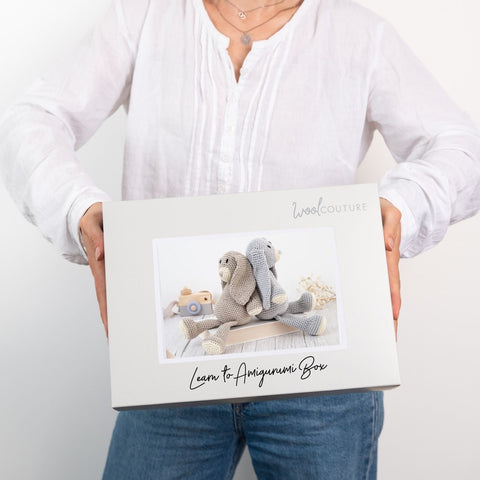 Woman holding Wool Couture Learn to Amigurumi Crochet Box for confident beginners