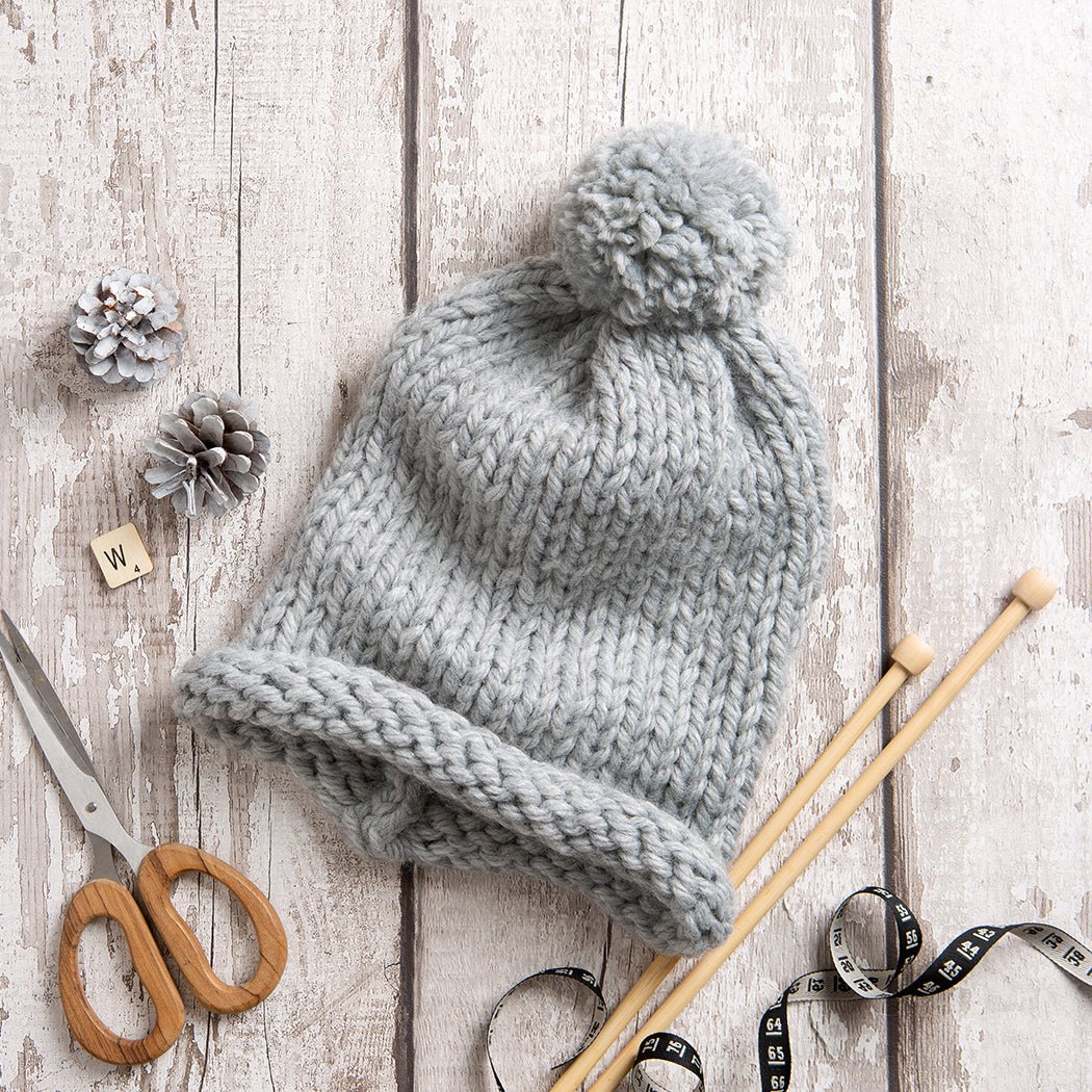 Premium Photo  Knitting gloves made of gray wool. top view.